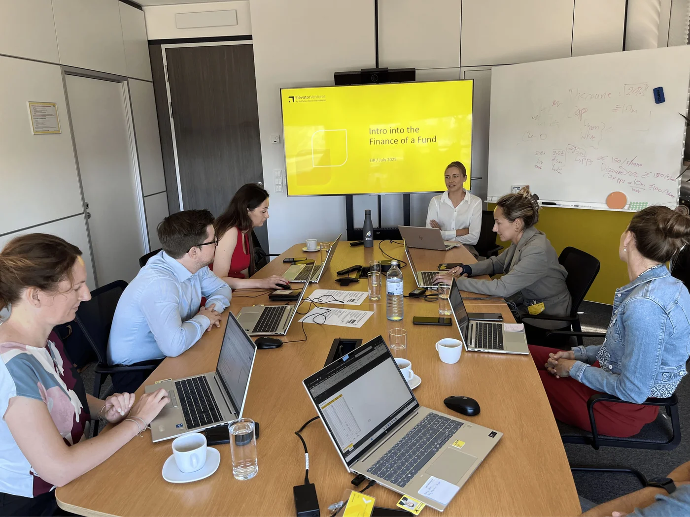 Session with laptops and presentation screen