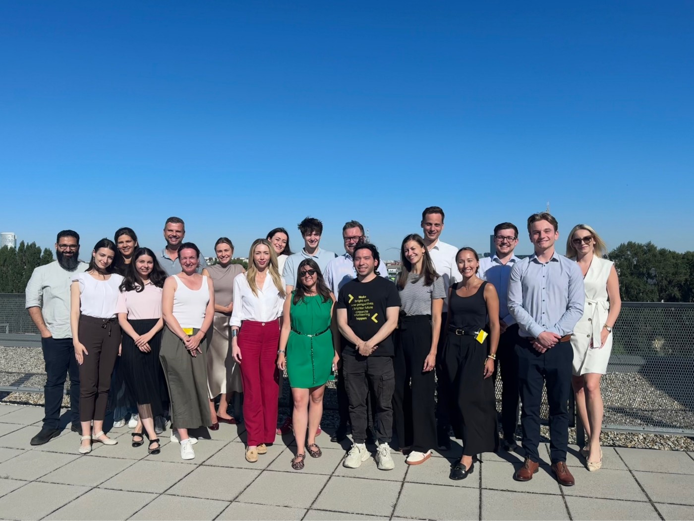 Group photo on rooftop under clear sky