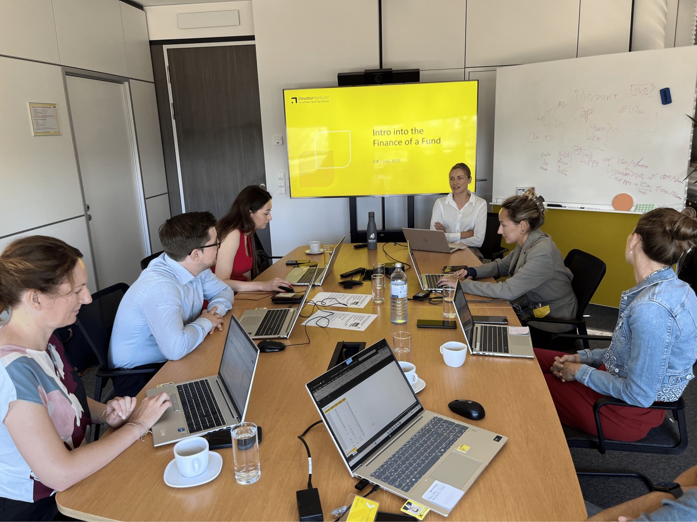 Session with laptops and presentation screen